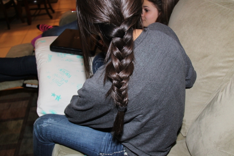 Брюнетка с косичками со спины