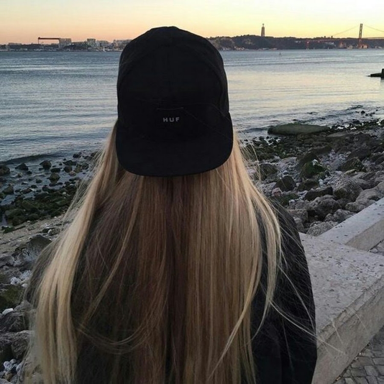 Блондинка в бейсболке со спины