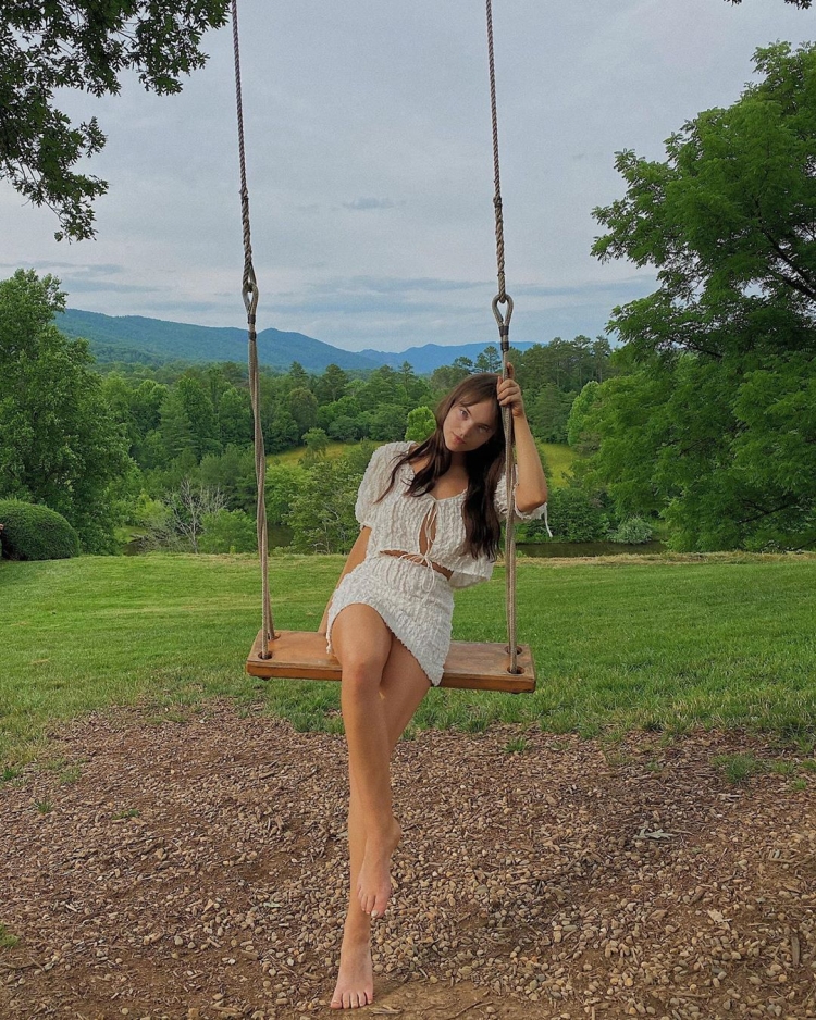 Девушка босиком на качелях